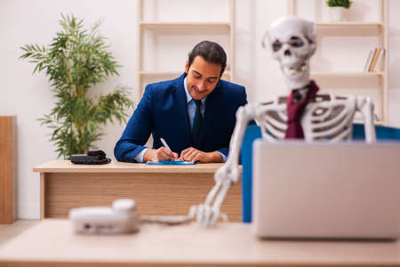 Dead employee working in the officeの写真素材