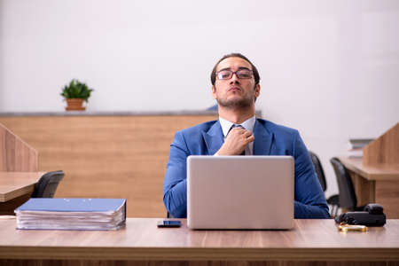 Young male employee sitting at workplaceの写真素材