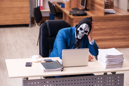 Devil businessman working in the officeの写真素材