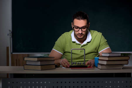 Young male student physicist working hard at night timeの写真素材