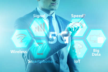 Businessman pressing button in 5g conceptの写真素材