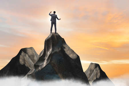 Businessman at the top of mountain in career conceptの写真素材