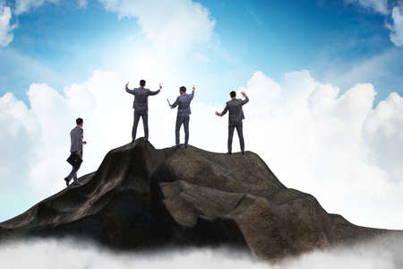 Businessman at the top of mountain in career conceptの写真素材