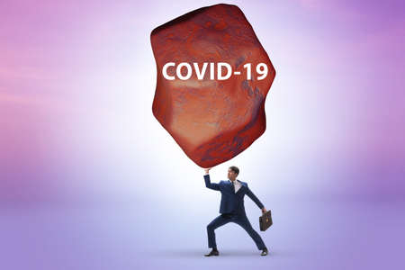 Businessman suffering from burden of covid pandemicの写真素材