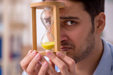 Young male employee unhappy with excessive work in the office