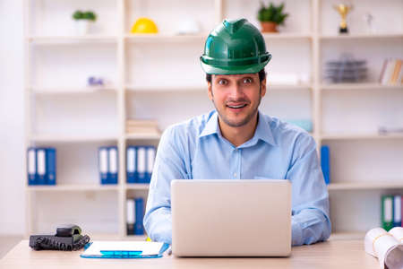 Young male architect working in the office