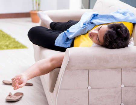 Man with mess at home after house partyの写真素材