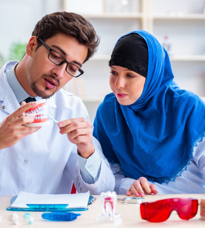 Dentist doctor and assistant working on new tooth implantの写真素材
