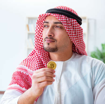 Arab man with bitcoin in cryptocurrency mining conceptの写真素材