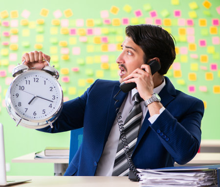 Businessman with many conflicting priorities in time managementの写真素材