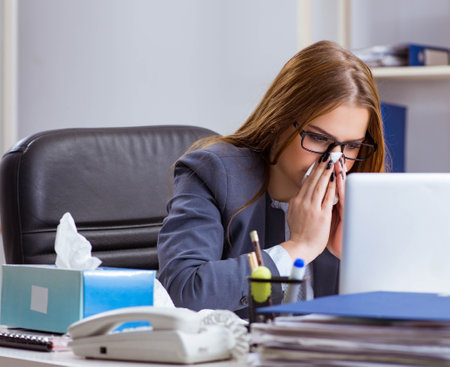 Businesswoman employee sick in the officeの写真素材