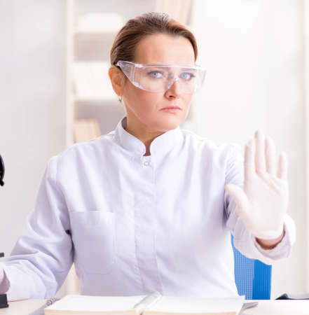 Woman chemist working in hospital clinic labの写真素材