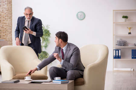 Two businessmen discussing project at workplaceの写真素材