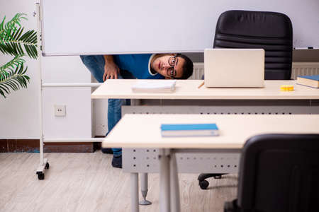 Young male student in the classroomの写真素材