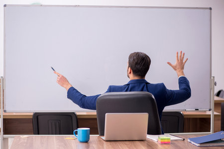 Young handsome employer in teleconference conceptの写真素材