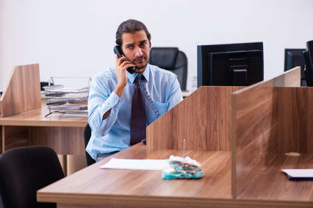 Young male employee working in the officeの写真素材