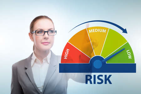 Businesswoman in risk metering and management conceptの写真素材