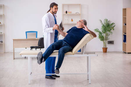 Old male patient visiting young male doctor radiologistの写真素材