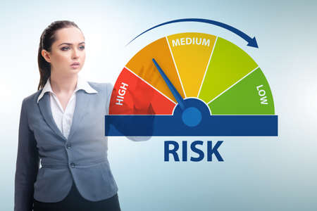 Businesswoman in risk metering and management conceptの写真素材