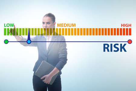 Businesswoman in risk metering and management conceptの写真素材