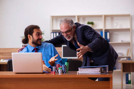Two male employees in gambling conceptの写真素材