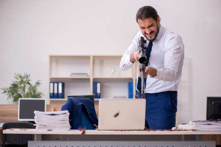 Young male employee and too many cockroaches in the officeの写真素材