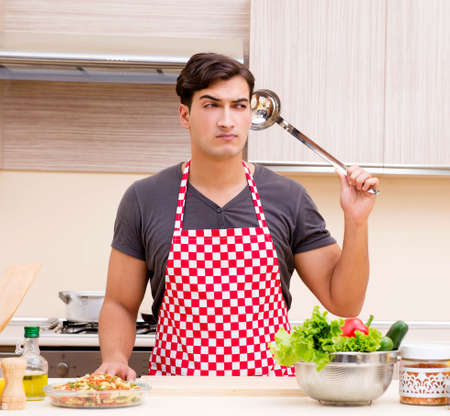 Man male cook preparing food in kitchenの写真素材