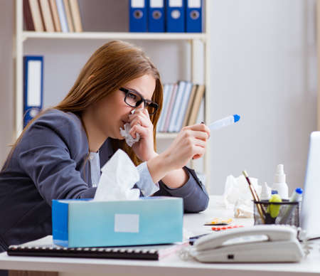 Businesswoman employee sick in the officeの写真素材