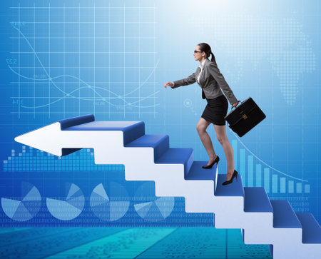 Businesswoman climbing career ladder in business conceptの写真素材