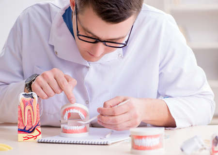Dentist working teeth implant in medical lab