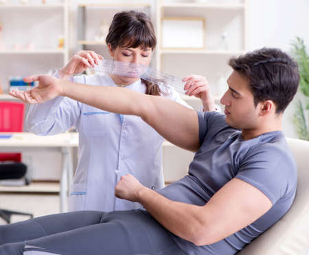 Doctor checking patients joint flexibility with gonimeterの写真素材