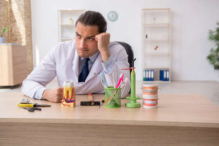 Young male doctor stomatologist working in the clinicの写真素材
