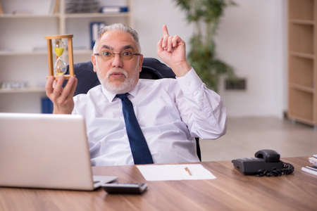 Old male employee in time management concept