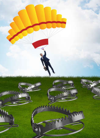 Businessman falling into trap on parachuteの写真素材