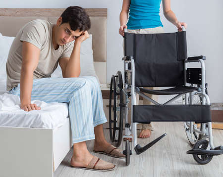Desperate man on wheelchair with his sad wife