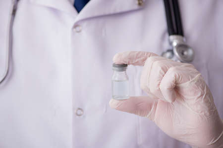 Young male doctor in vaccination concept