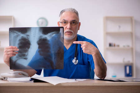 Old male doctor radiologist working in the clinicの写真素材