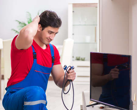 Professional repair engineer repairing broken tvの写真素材