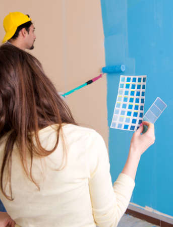 Husband and wife doing renovation at homeの写真素材