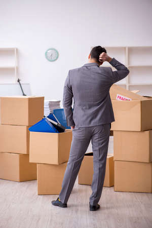 Young male employee in relocation conceptの写真素材