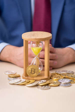 Young man earning money via Internet in time management conceptの写真素材