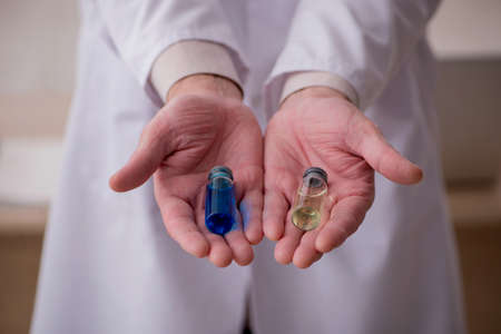 Old male doctor in vaccination concept