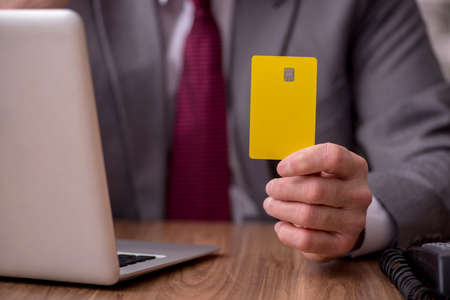 Old male employee in ecommerce conceptの写真素材