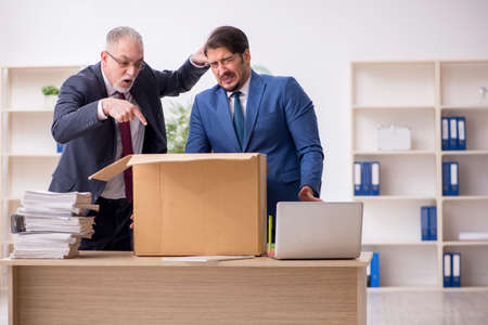 Two male employees in dismissal conceptの写真素材