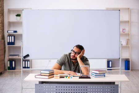 Young male student preparing for exams in the classroomの写真素材