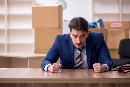Young male employee in relocation conceptの写真素材