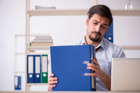 Young male employee working in the officeの写真素材