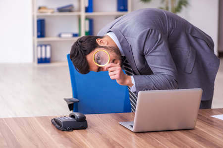 Young handsome auditor working in the officeの写真素材