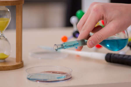 Schoolboy studying chemistry in the classroom