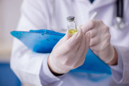 Old male doctor working in the clinicの写真素材